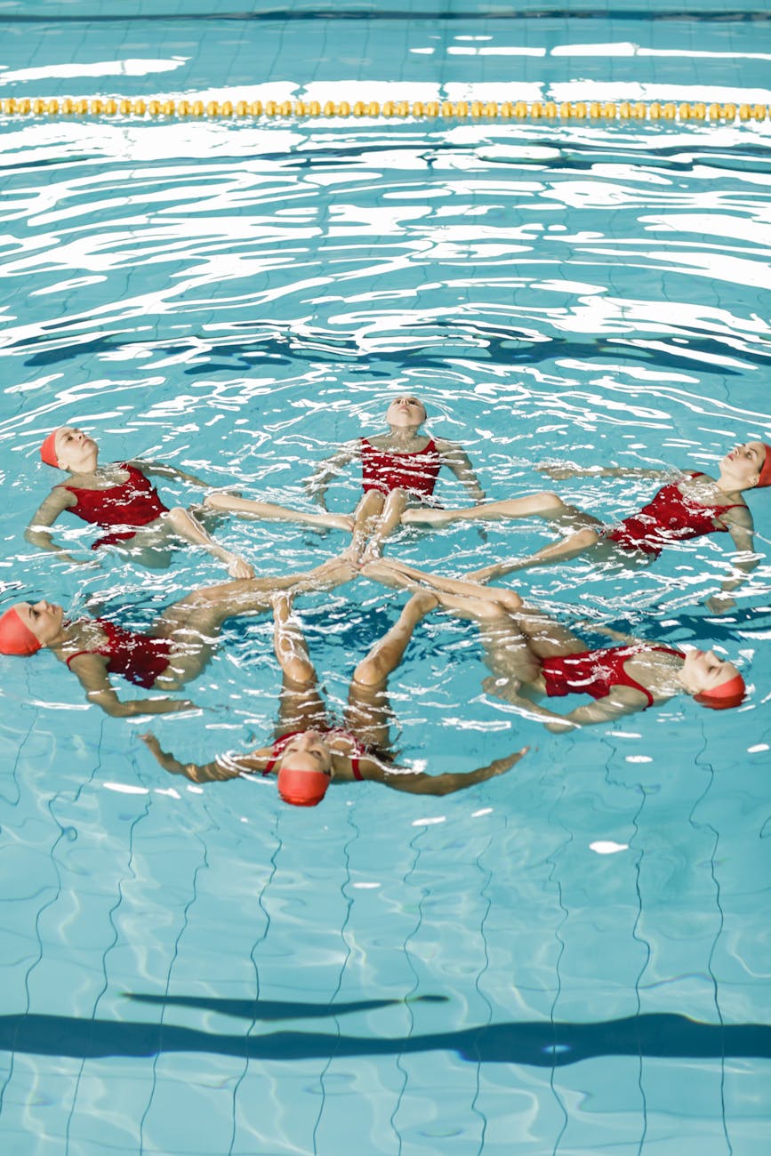 synchronized swimming team on training in pool