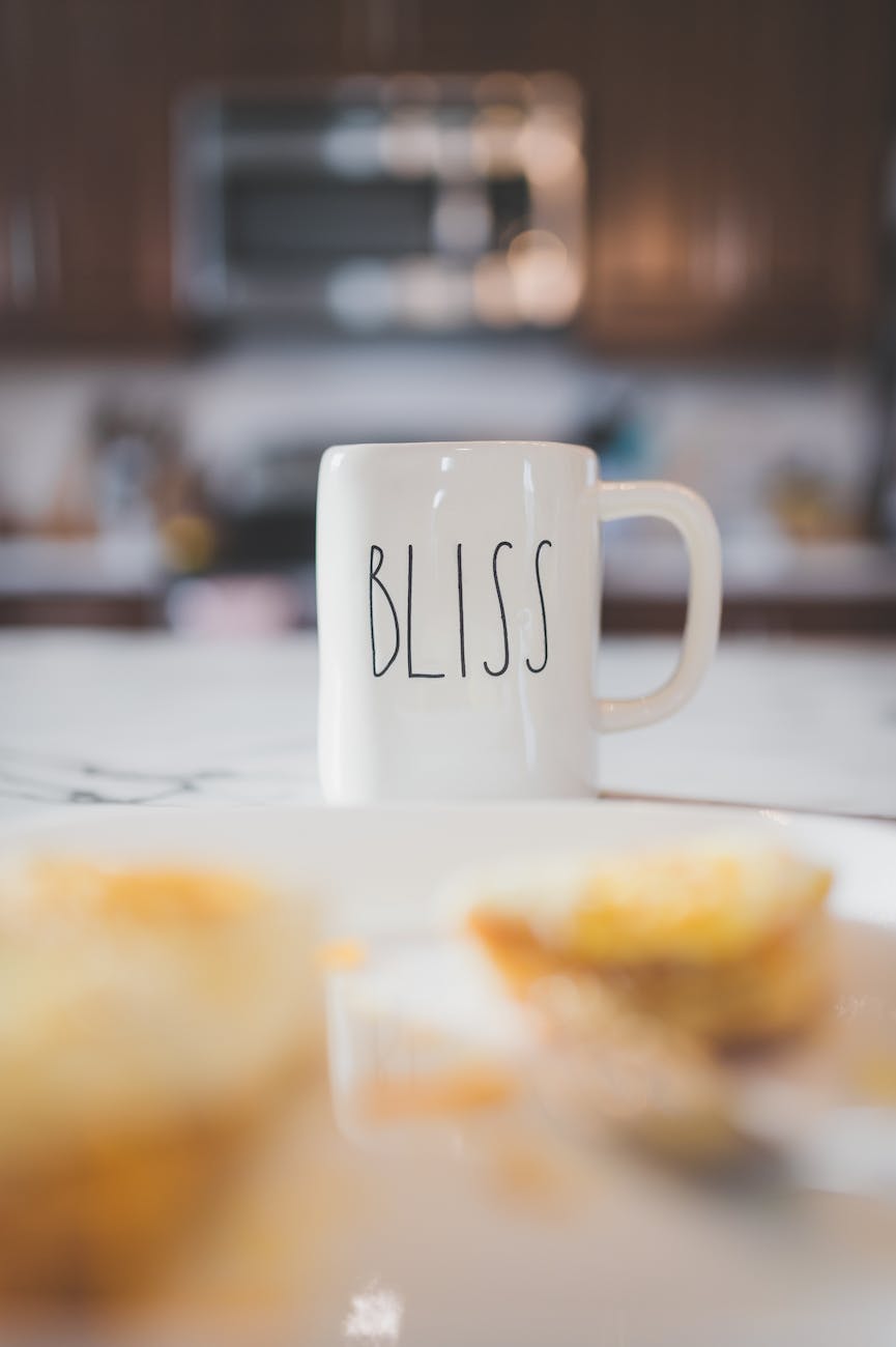 a white ceramic cup with bliss word printed