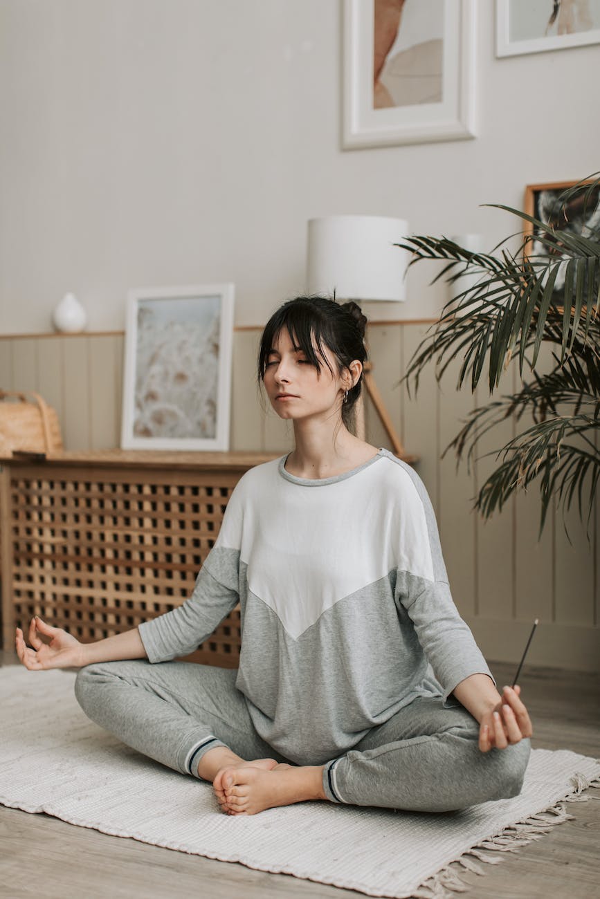 woman in long sleeve shirt sitting on a rug