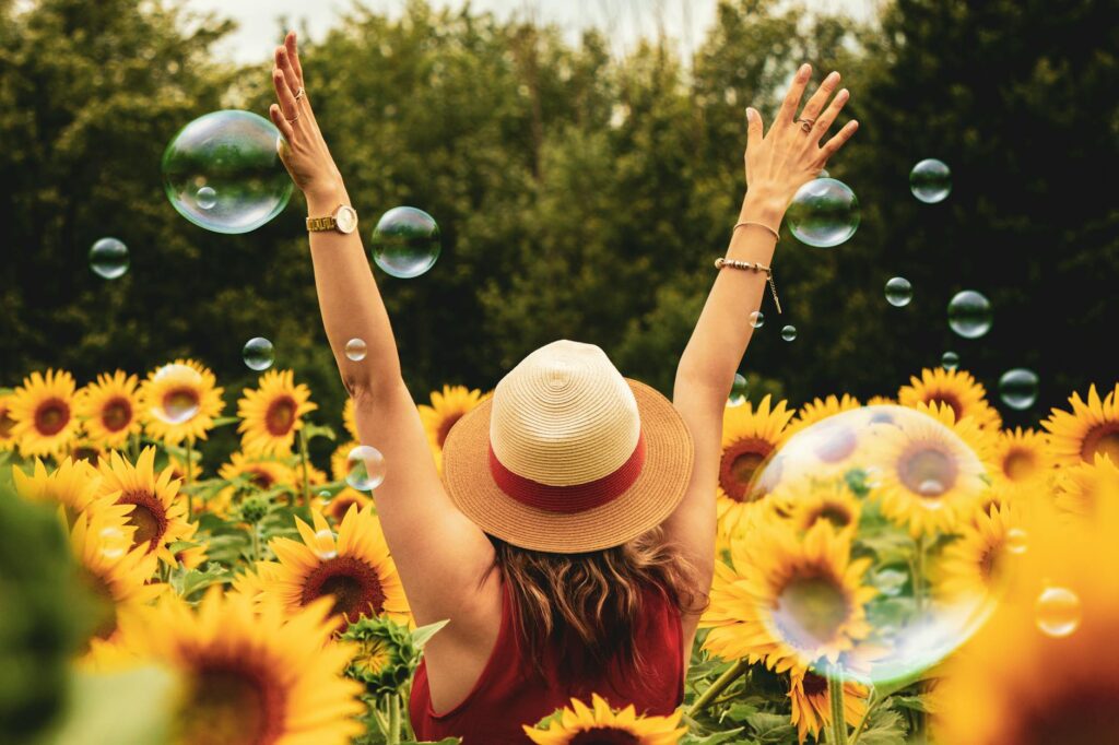 woman surrounded by sunflowers